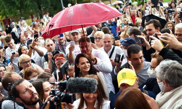 People surround presidential candidate Svetlana Tikhanovskaya as she arrives to cast her vote at a polling station during the presidential election in Minsk on Sunday.