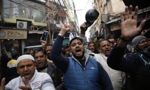 Protesters shout and march through a lane near the historic Red Fort in New Delhi, India.