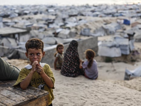 Palestinian people spend time on the beach to escape the oppressive heat inside their tents as people deprived of basic necessities struggle to survive in harsh living conditions in Gaza City.