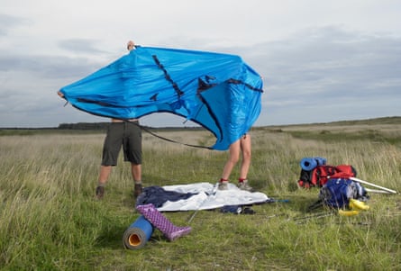 Young couple setting up tent