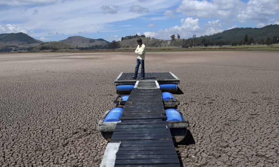 A Colombian engineer, Hernan Sandino, stands on a dock in the Suesca lagoon, which has dried up due to a strong drought exacerbated by climate change. March 2021.