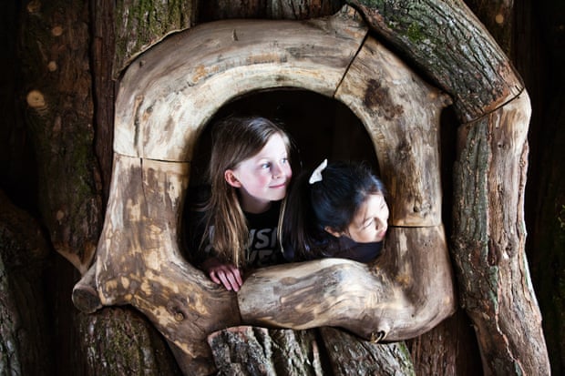 Children take a look out of one of the park’s indoor attractions, a massive hollow oak tree.