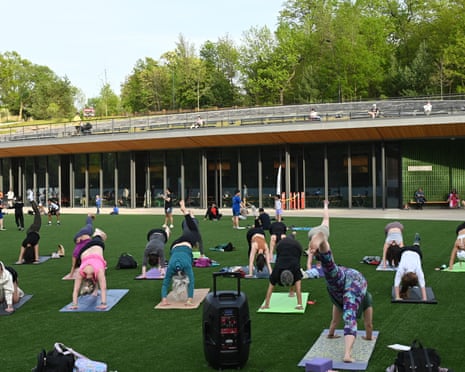 A free Yoga class on the artifical grass surface ioutside the new Davis Center.