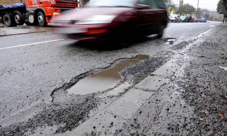 A car dodging a pothole