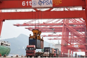 A crane loads a container onto a truck at Lianyungang Port in Lianyungang in China’s eastern Jiangsu province today