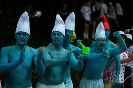 Five men dressed as smurfs encourage the riders
