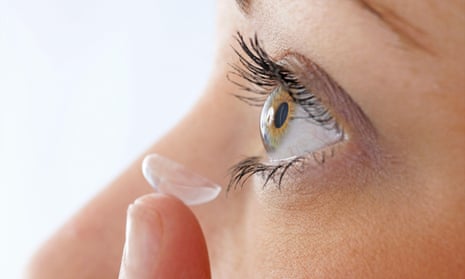 A woman using a contact lens