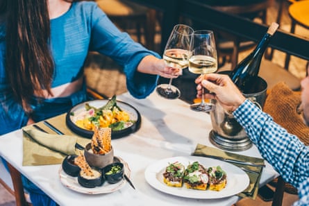 couple drinking white wine and toasting