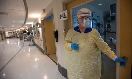 A healthcare worker walks into a Covid patient’s room in Torrance, California, on 30 July. 
