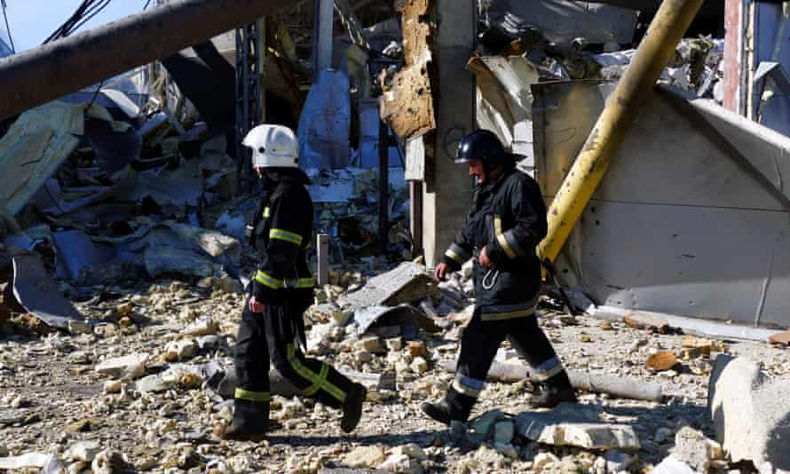 Emergency services work at the site of the shelled shopping centre, on Tuesday, in Odesa.