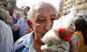 A man carries sugar bought from a government truck in Cairo, where it has all but vanished from supermarkets.