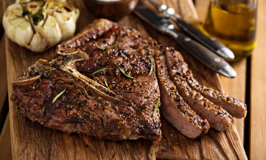 A seared steak on a cutting board.