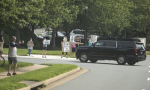 Protesters meet Trump’s motorcade at Trump National Golf Club Saturday in Sterling, Virginia.