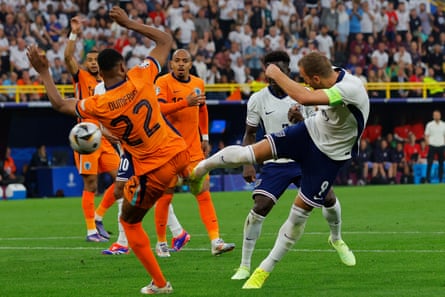 Denzel Dumfries of the Netherlands, left, fouls England’s Harry Kane for a penalty during the Euro 2024 semi-final match between Netherlands and England.