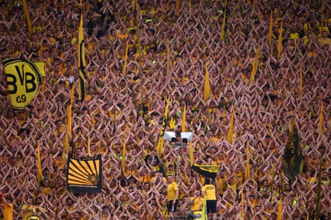 Borussia Dortmund fans show their support as they applaud and hold flags prior to the Champions League semi-final first leg match against Paris Saint-Germain.