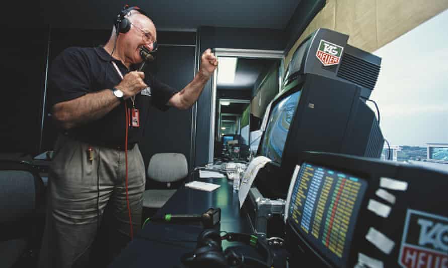 Murray Walker studying the television monitors in the commentary box at the Formula One Japanese Grand Prix in 2001.