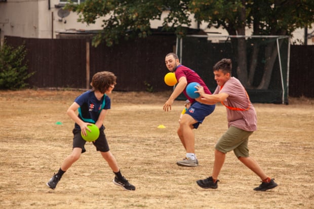 Wilf Brooke (centre) supervises and plays with the children as they take part in the club's summer cricket camp.