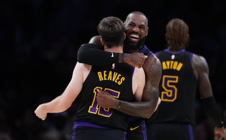 LeBron James embraces teammate Austin Reaves during Tuesday’s game.