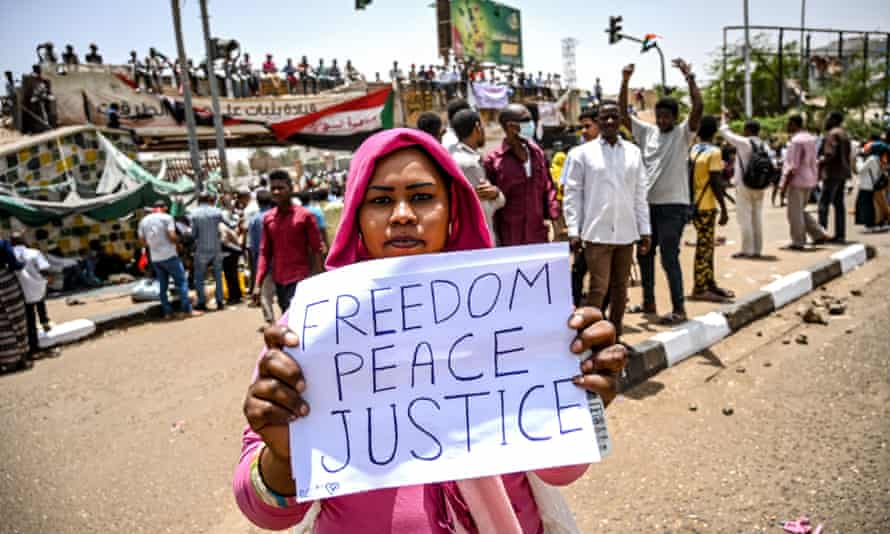 A Sudanese protester holds up a placard during the biggest protest since the former president Omar al-Bashir was ousted.