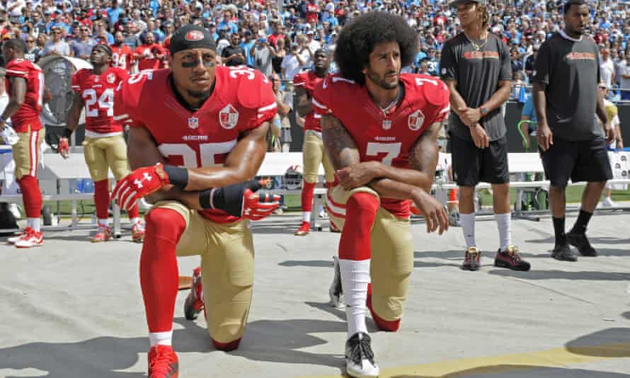San Francisco 49ers’ Colin Kaepernick (right) and Eric Reid take the knee during the national anthem before an NFL game.