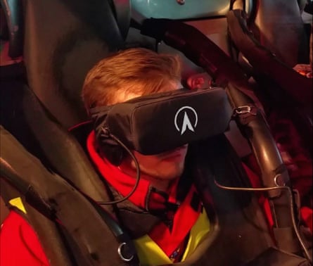 A person is strapped in to the ride and wearing a virtual reality headset