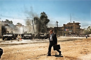 Baghdad, 2004 An Iraqi man walks by the scene of an attack on US Army Humvees that caused several American casualties
