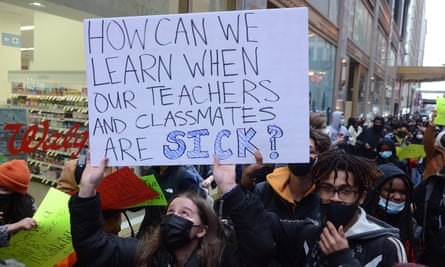 sign says ‘how can we learn when our teachers and classmates are sick?’
