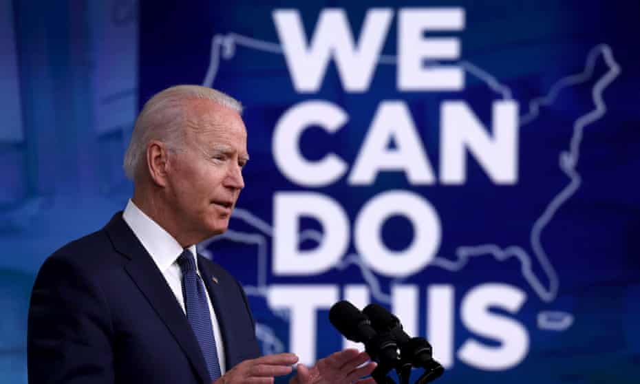 President Joe Biden stands at a podium in front of a backdrop that reads "We can do this" as he speaks on his administration's coronavirus response.