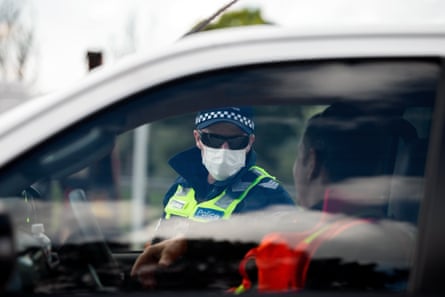 Police are seen checking driver’s licenses at a roadblock south of Gisborne.
