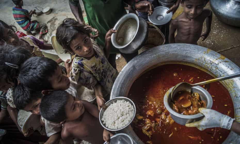 Rohingya children receive food from the Turkish aid agency in Cox’s Bazar, Bangladesh.