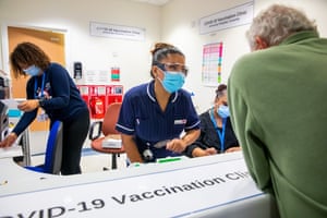 May Parsons talks to a patient at the vaccination clinic