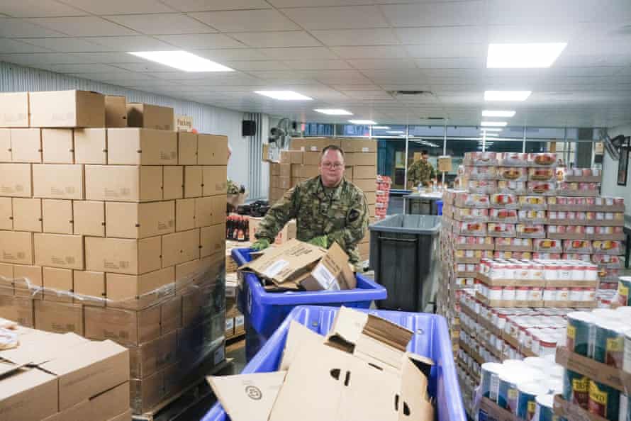 A member of the Ohio National Guard assists in repackaging emergency food boxes for distribution at the Columbus food bank last week.