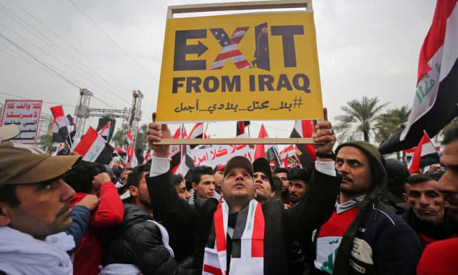 Protesters raise a placard as supporters of Moqtada al-Sadr gather in Baghdad demanding the expulsion of US forces