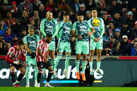 The Fulham wall attempts to defend a free kick against Brentford.