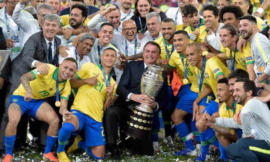 Brazil, with president Jair Bolsonaro holding the trophy, celebrate winning the 2019 Copa America. Brazil has offered to host it this year but is struggling with Covid cases.