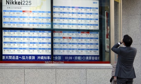 A man looks at an electronic stock board showing Japan’s Nikkei 225. The volatility affecting global markets last month appears set to continue.