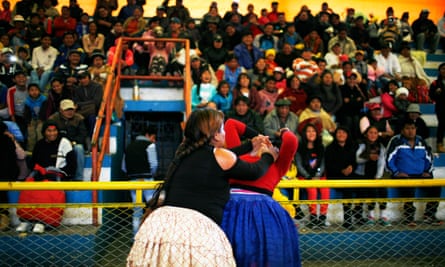 Cholita wrestlers fight it out as the crowd goes wild.