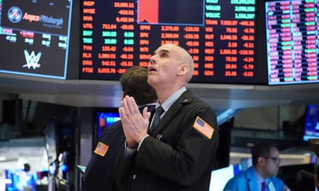 Traders work in the New York stock exchange