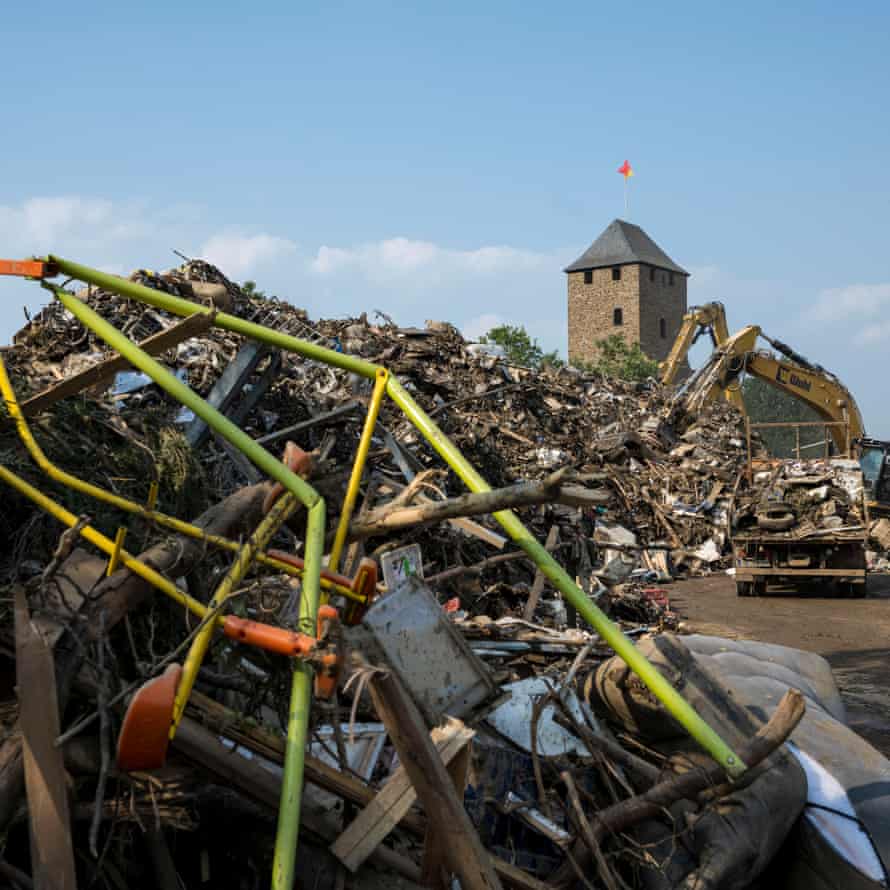 The rubbish and destroyed home furnishings in front of the old city wall are piled up.
