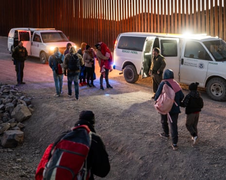 Migrants turn themselves in to US Customs and Border Patrol officers after crossing over a section of border wall at Ruby, Arizona.