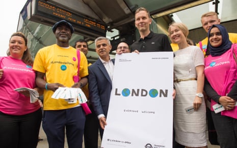 Sadiq Khan unveils London is Open poster by artist David Shrigley (right) at Southwark Underground station.