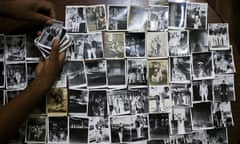 In this Dec. 20, 2016 photo, photographer Luis Maldonado shows negatives made by his grandfather, father or uncle, using this old wooden box camera, at his home in Santiago, Chile. The first wooden box camera arrived in Chile in 1911 and seven years later there were about 300 box photographers in the country, according to Chilean historian Octavio Cornejo. (AP Photo/Esteban Felix)