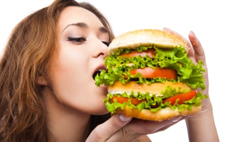 Happy Young Woman Eating big yummy Burger isolatedDGK942 Happy Young Woman Eating big yummy Burger isolated