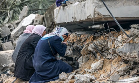 Women cry where a relative is believed to be trapped in debris after Israeli bombardment in Rafah, Gaza