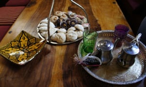 Tea tray with cups and teapot on a table next to a plate of pastries at Restaurante-Teteria Almedina, Almeria, Spain.