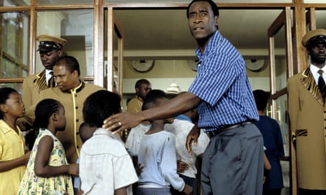 An image from Hotel Rwanda, depicting Paul Rusesabagina, played by Don Cheadle, helping Tutsi children to safety.