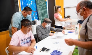 Scrutineers wearing protective face masks and shields work during the second round of the French municipal elections at a polling station in Marseille, southern France, on 28 June, 2020. (Photo by CLEMENT MAHOUDEAU/AFP via Getty Images)