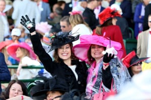 Women wave from the stands