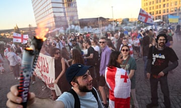 Georgian demonstrators protesting against the ‘foreign agents’ law gather for a concert aimed at raising funds to pay police fines of their fellow protesters, in Tbilisi.