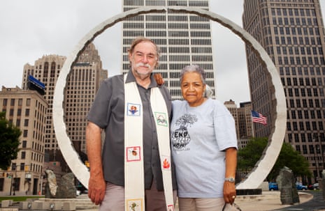 Marian Kramer and Rev Bill Wylie-Kellermann stand beneath Transcending, the monument built to honor Detroit’s Labor Movement.